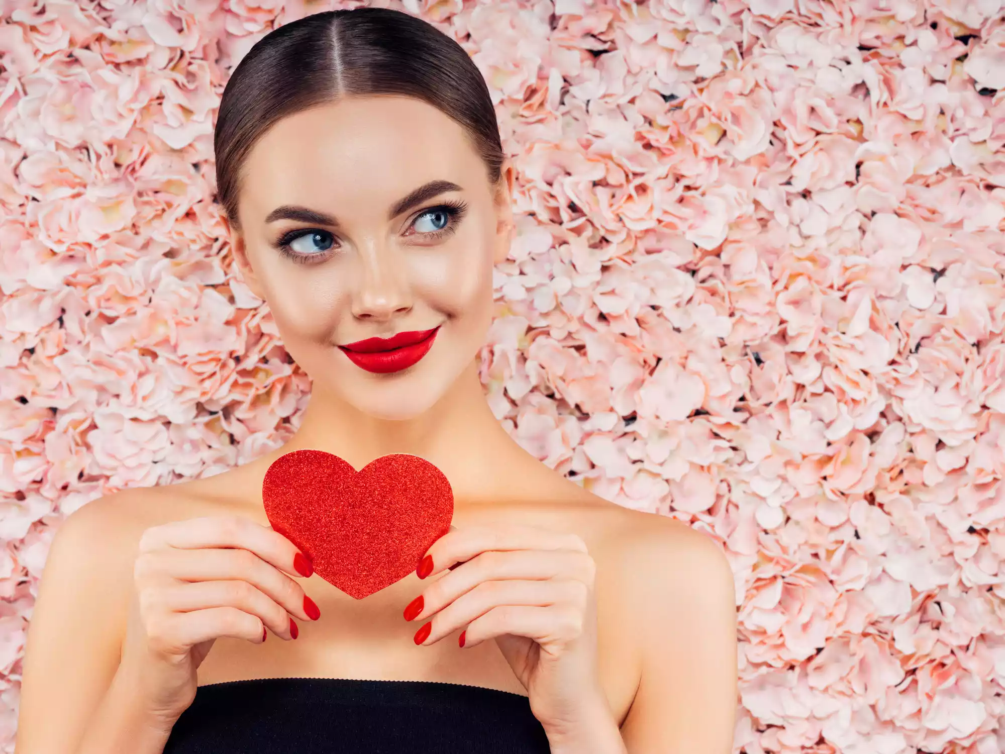 Happy woman celebrating Valentine’s Day, radiating confidence and joy.