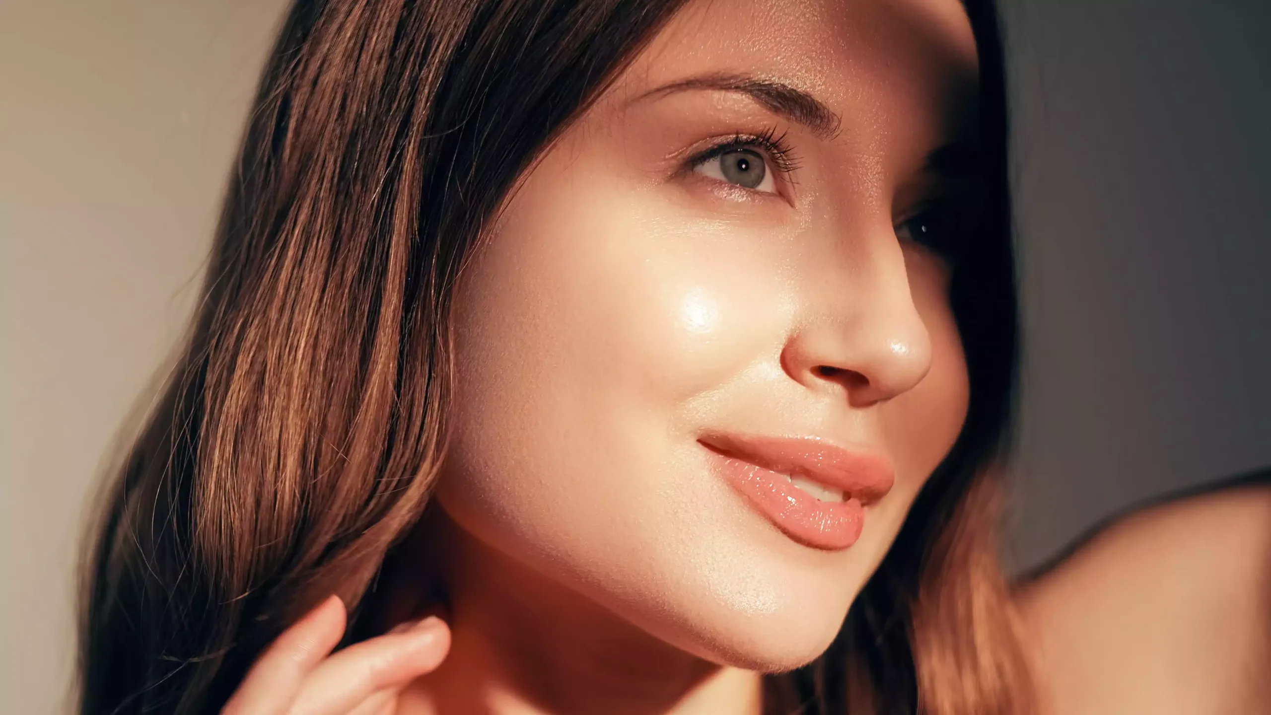 Smiling woman with glowing skin, perfect for facelift surgery.
